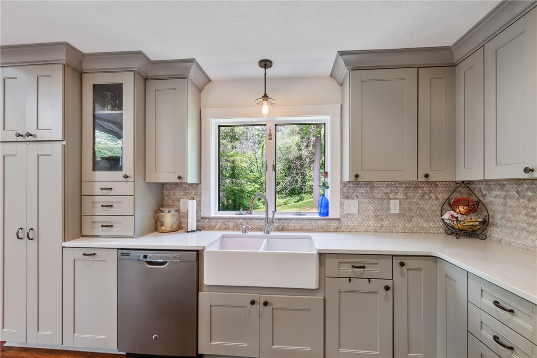 7733 East Port Bay Road Wolcott, NY 14590 - Photo 22 of 49 Super FUNCTIONAL kitchen - everything has its place! Custom tile backsplash too!