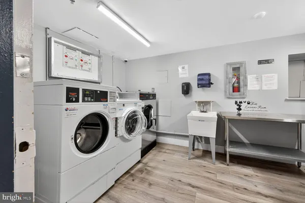 a living room with furniture a flat screen tv and a table