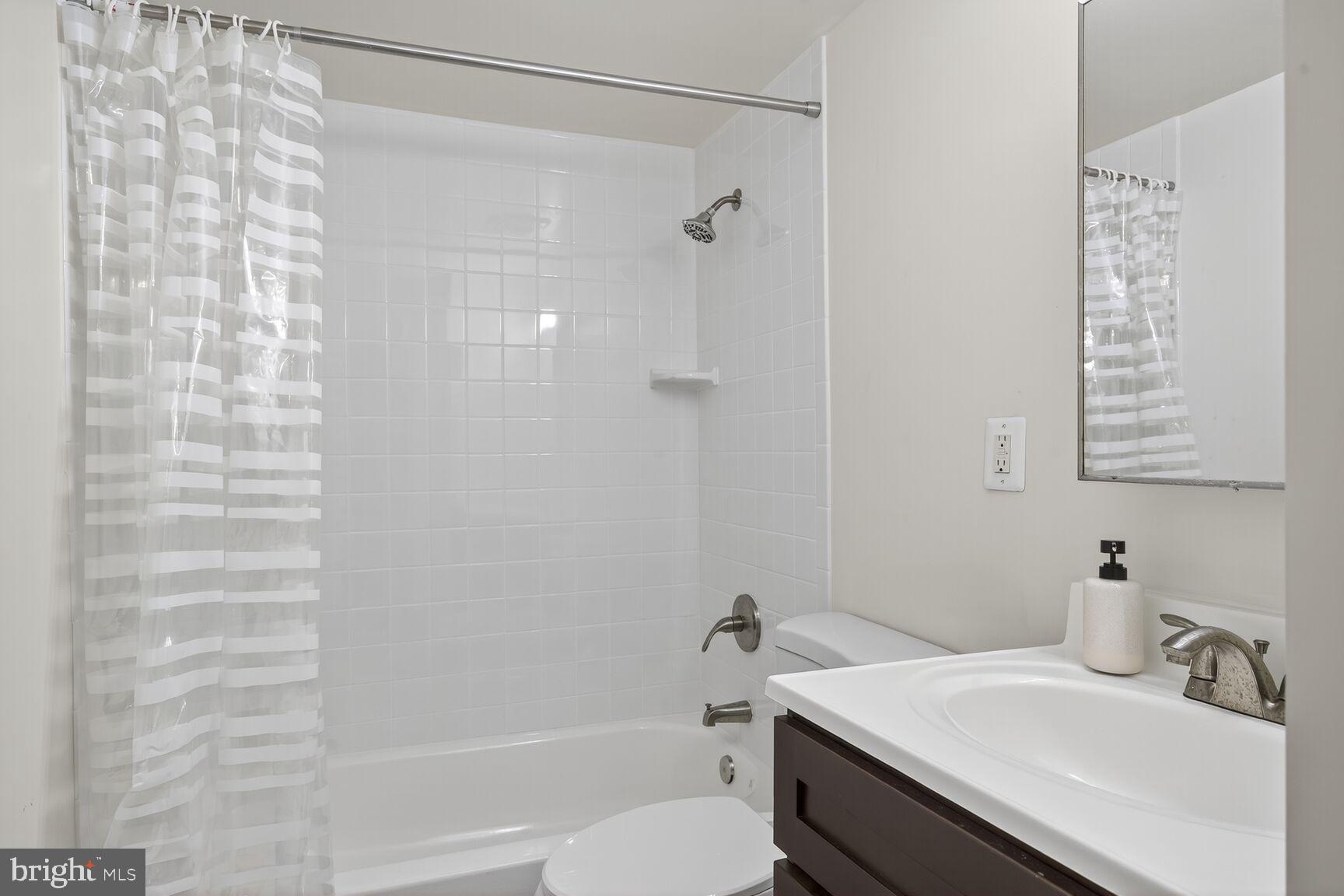 1440 W Street Northwest, Unit 106 Washington, DC 20009 - Photo 16 of 25 a bathroom with a sink and a mirror