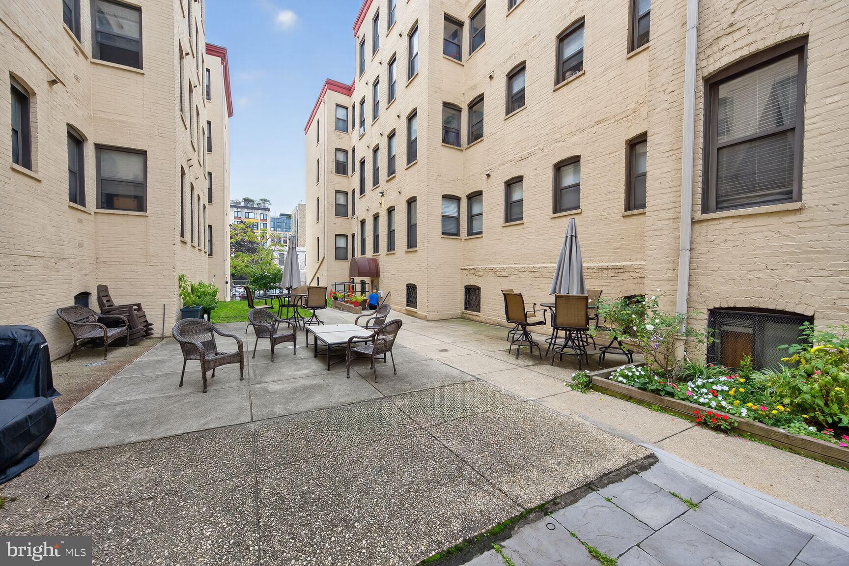 1440 W Street Northwest, Unit 106 Washington, DC 20009 - Photo 21 of 25 a view of a patio with couches and a fireplace