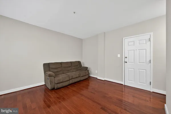 a living room with hard wood floors and a couch