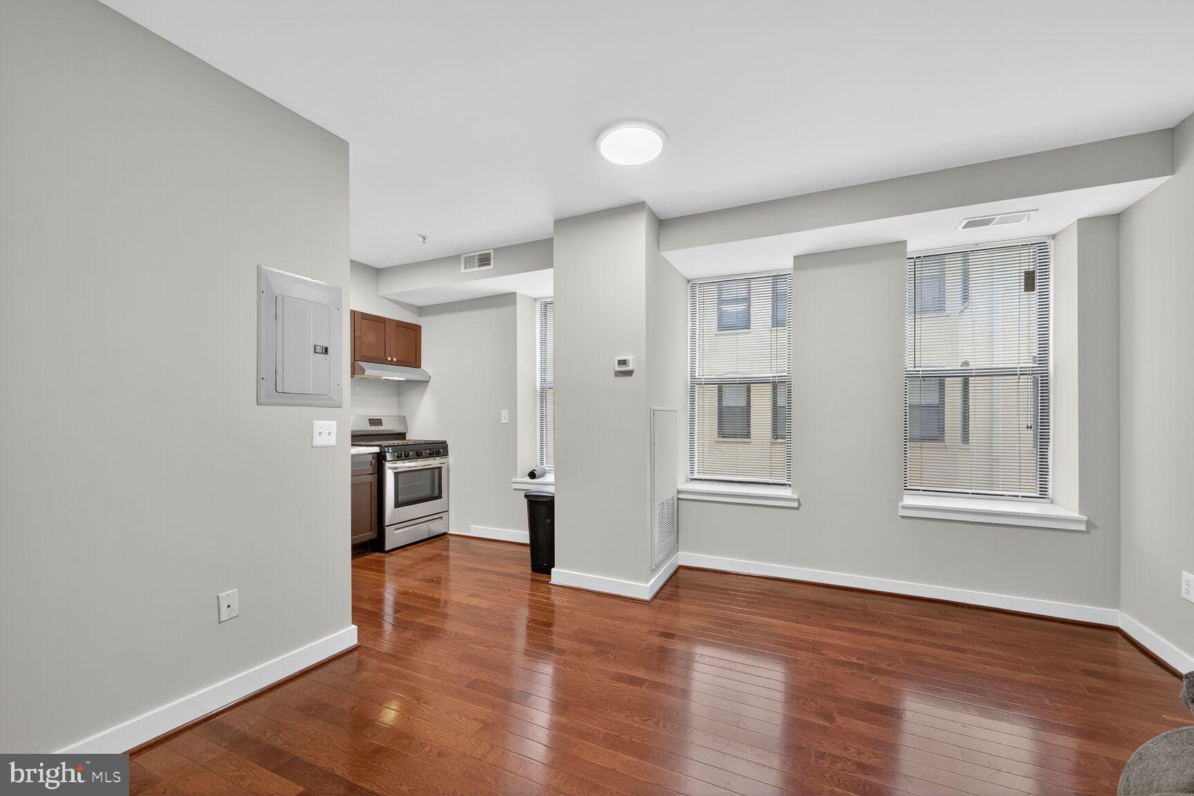 1440 W Street Northwest, Unit 106 Washington, DC 20009 - Photo 6 of 25 a view of a kitchen with wooden floor and a window