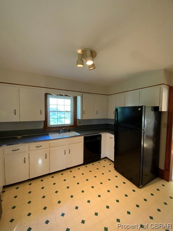 14 Light Street Heathsville, VA 22473 - Photo 16 of 18 Kitchen featuring light tile floors, sink, white cabinetry, and black appliances