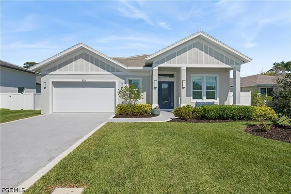 a front view of a house with a yard and garage