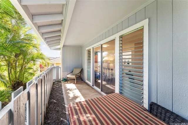 a balcony with wooden floor and furniture