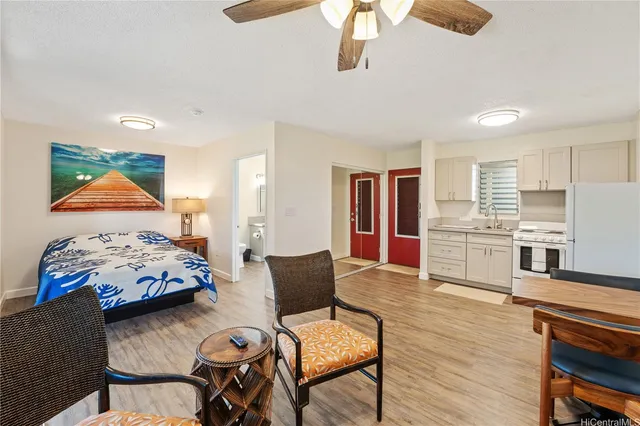 a bedroom with furniture and a wooden floor