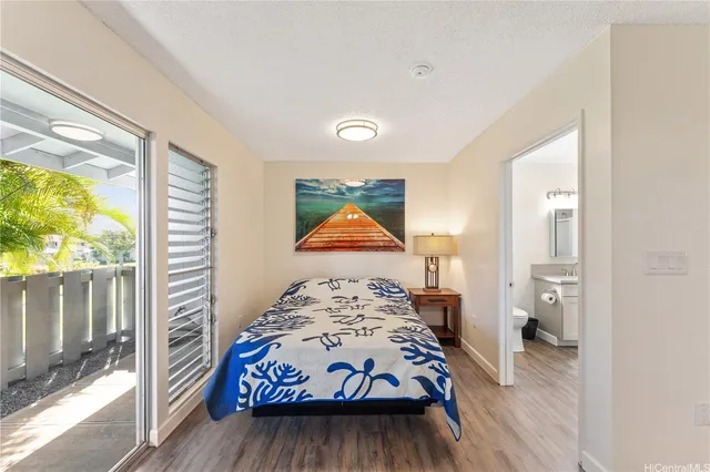 a bedroom with a bed and a painting on the wall