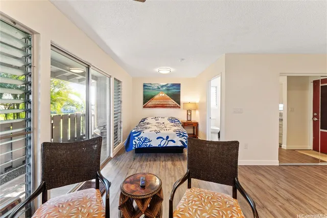 a view of a livingroom with furniture window and wooden floor