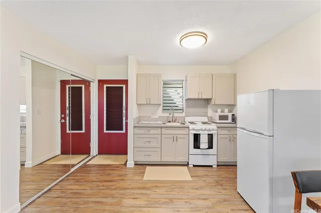 a kitchen with stainless steel appliances granite countertop a refrigerator and a stove top oven