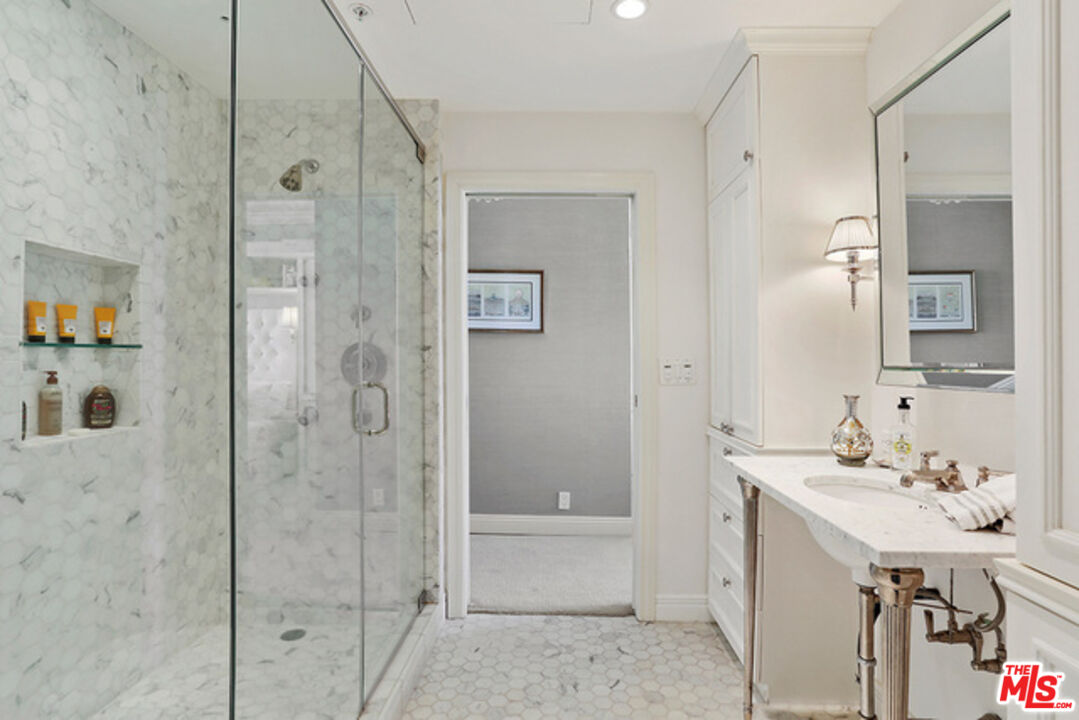 10580 Wilshire Boulevard, Unit 19NW Los Angeles, CA 90024 - Photo 11 of 20 a bathroom with a sink a toilet and shower