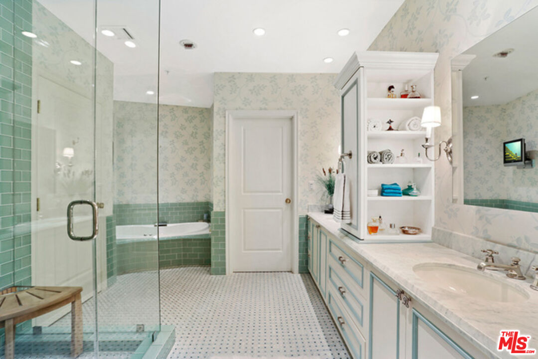 10580 Wilshire Boulevard, Unit 19NW Los Angeles, CA 90024 - Photo 14 of 20 a bathroom with a double vanity sink a mirror and a shower