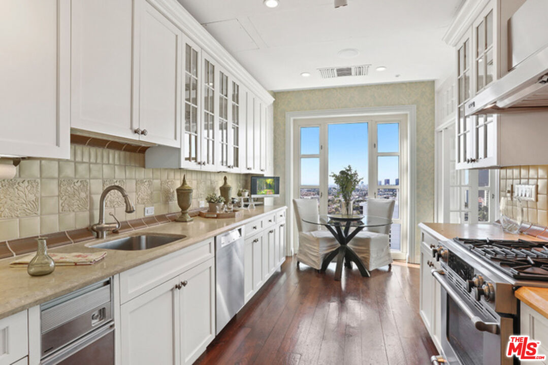 10580 Wilshire Boulevard, Unit 19NW Los Angeles, CA 90024 - Photo 6 of 20 a kitchen with sink stove and cabinets