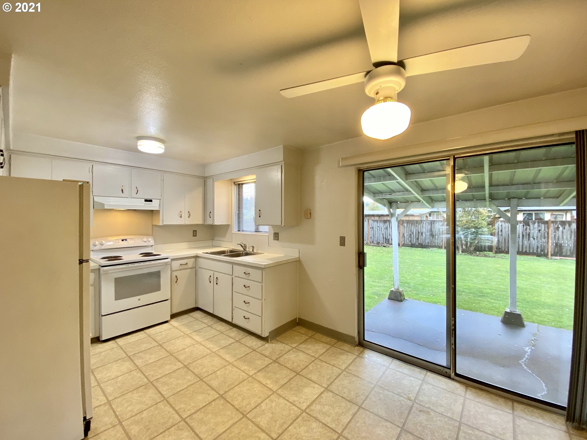 464 South 39th Place Springfield, OR 97478 - Photo 3 of 18 a kitchen with a sink and a refrigerator