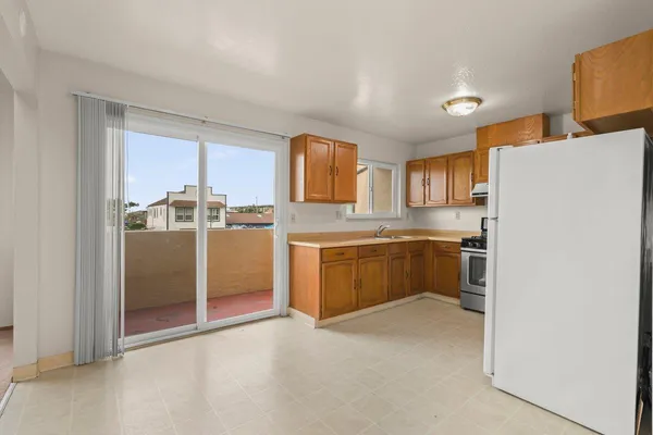 a kitchen with stainless steel appliances a refrigerator and a stove