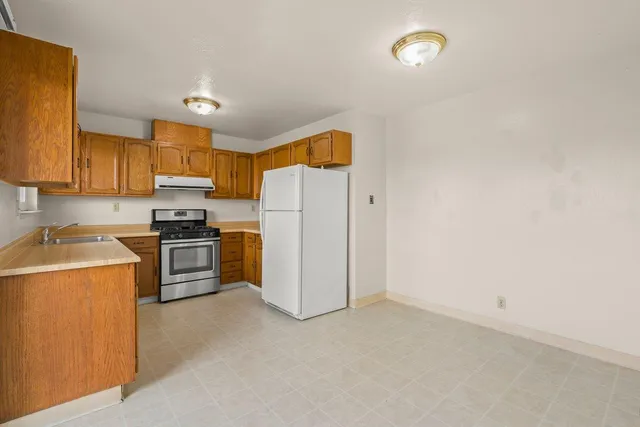 a kitchen with a refrigerator sink and stove