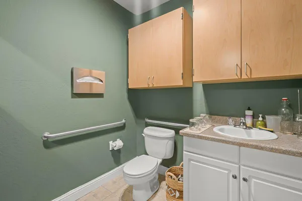 a bathroom with a sink a toilet and a mirror