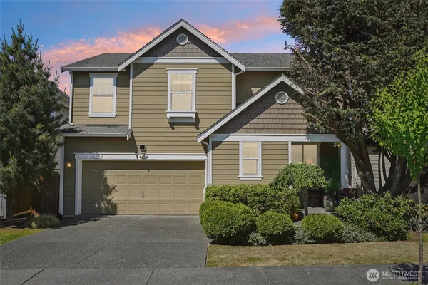 a front view of a house with garage