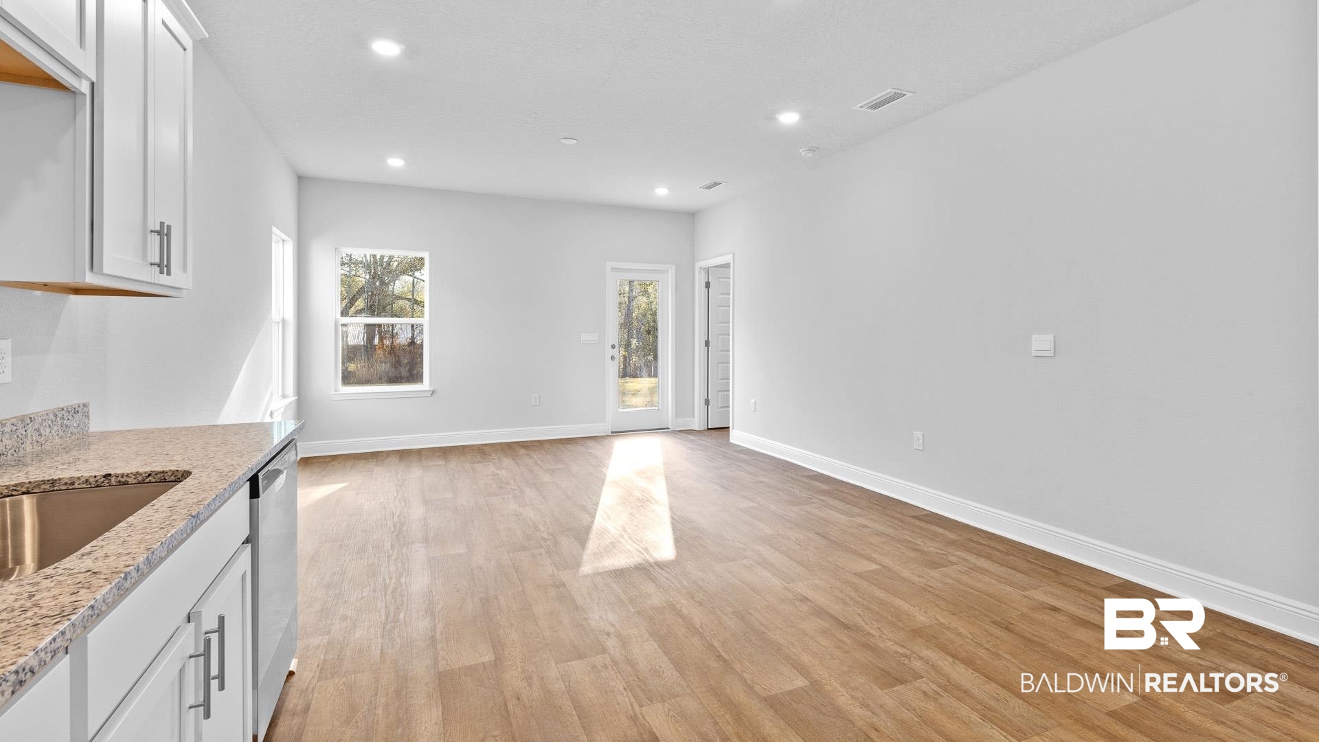13356 Shea Circle Foley, AL 36535 - Photo 4 of 15 Open-concept living space featuring wood-finish flooring, recessed lighting, and crisp white baseboards