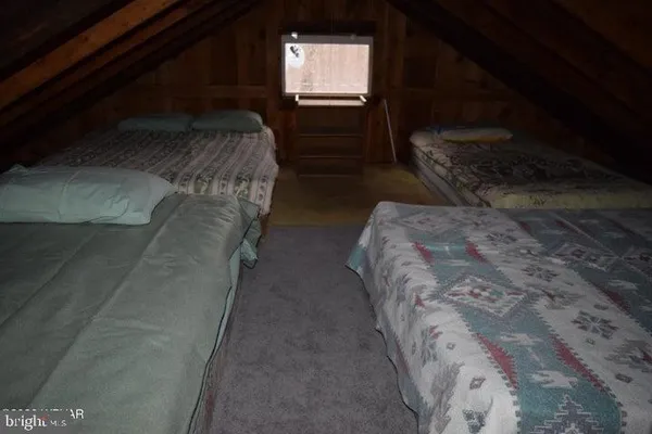 a bed sitting in a bedroom next to a window