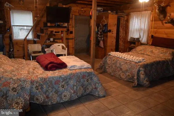 a bedroom with a bed and a refrigerator