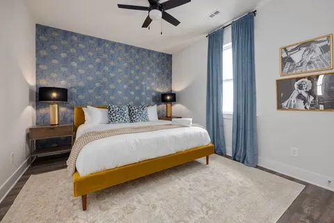 a bedroom with a bed and wall painting