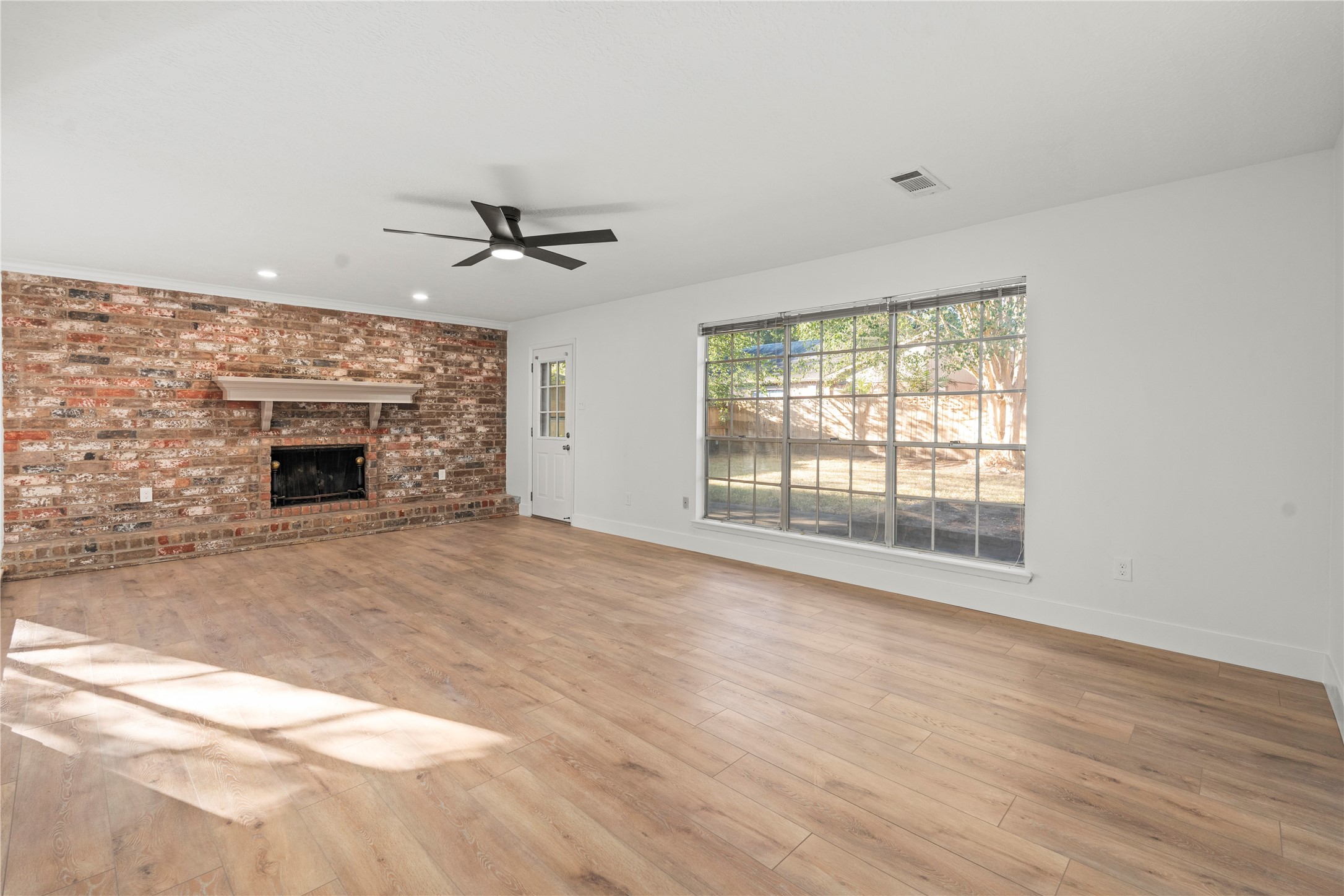 19415 Enchanted Oaks Drive Spring, TX 77388 - Photo 11 of 48 an empty room with chandelier fan and windows