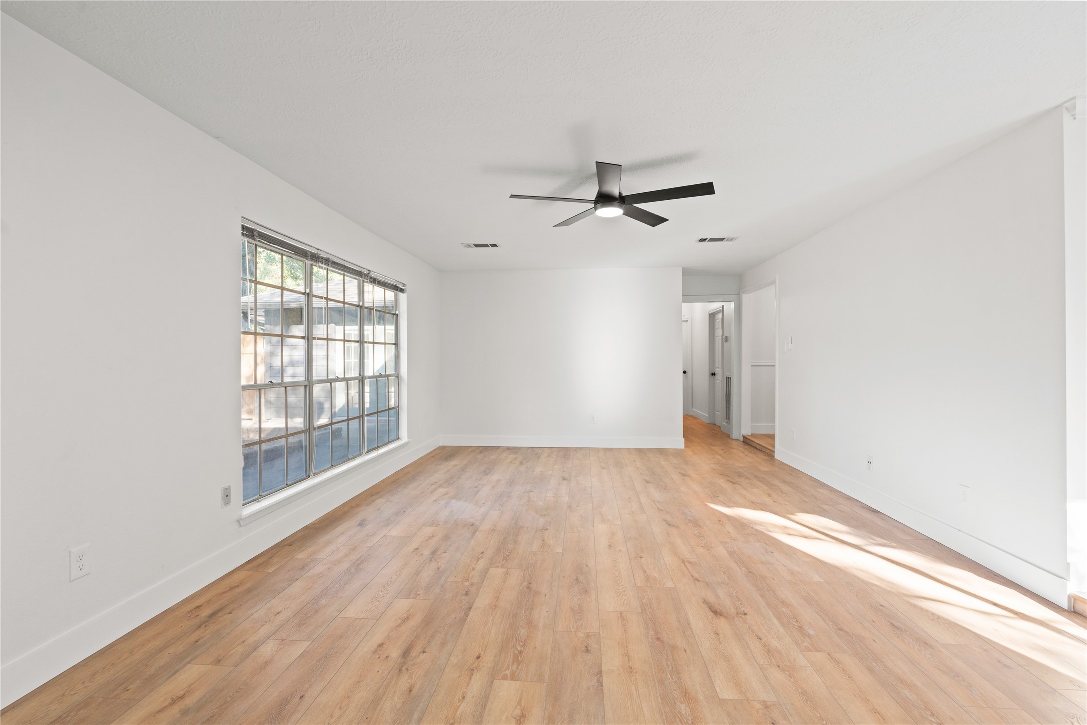 19415 Enchanted Oaks Drive Spring, TX 77388 - Photo 24 of 48 a view of an empty room with a window and wooden floor