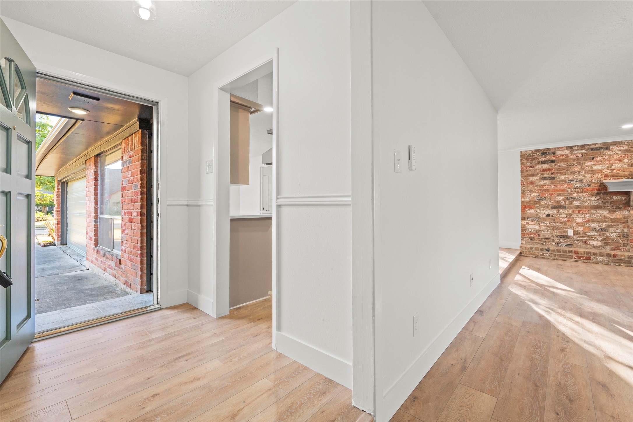 19415 Enchanted Oaks Drive Spring, TX 77388 - Photo 3 of 48 a view of hallway with livingroom and wooden floor