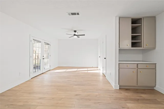 a view of an empty room with closet and a window