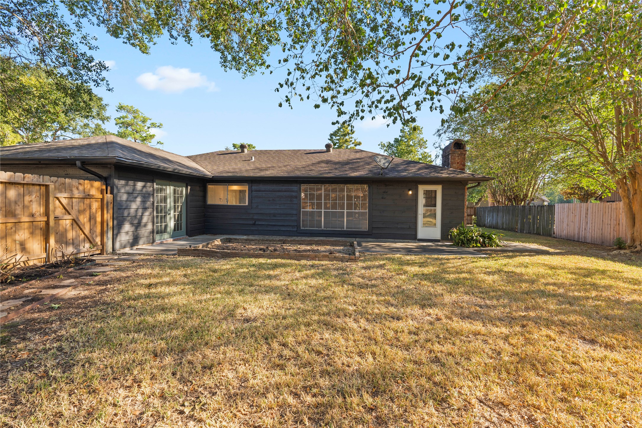 19415 Enchanted Oaks Drive Spring, TX 77388 - Photo 45 of 48 a front view of a house with a garden