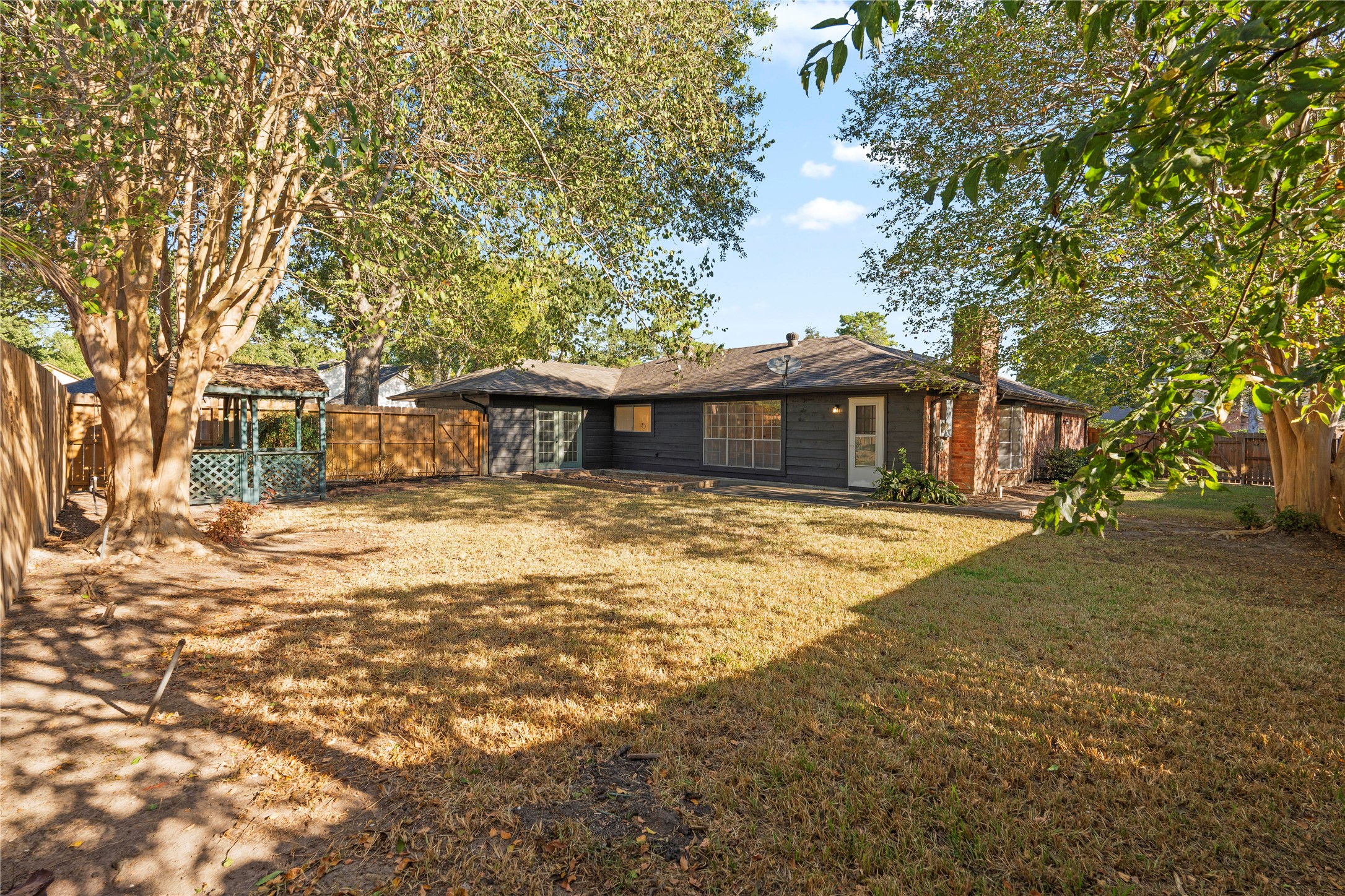 19415 Enchanted Oaks Drive Spring, TX 77388 - Photo 46 of 48 a front view of a house with a garden