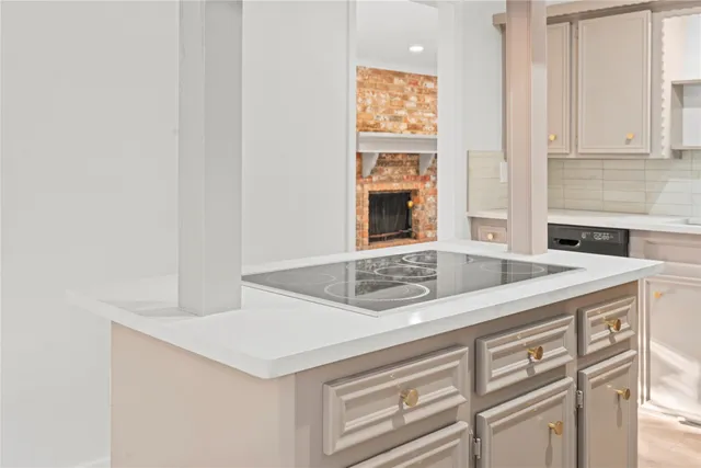 a kitchen with granite countertop cabinets stove and sink