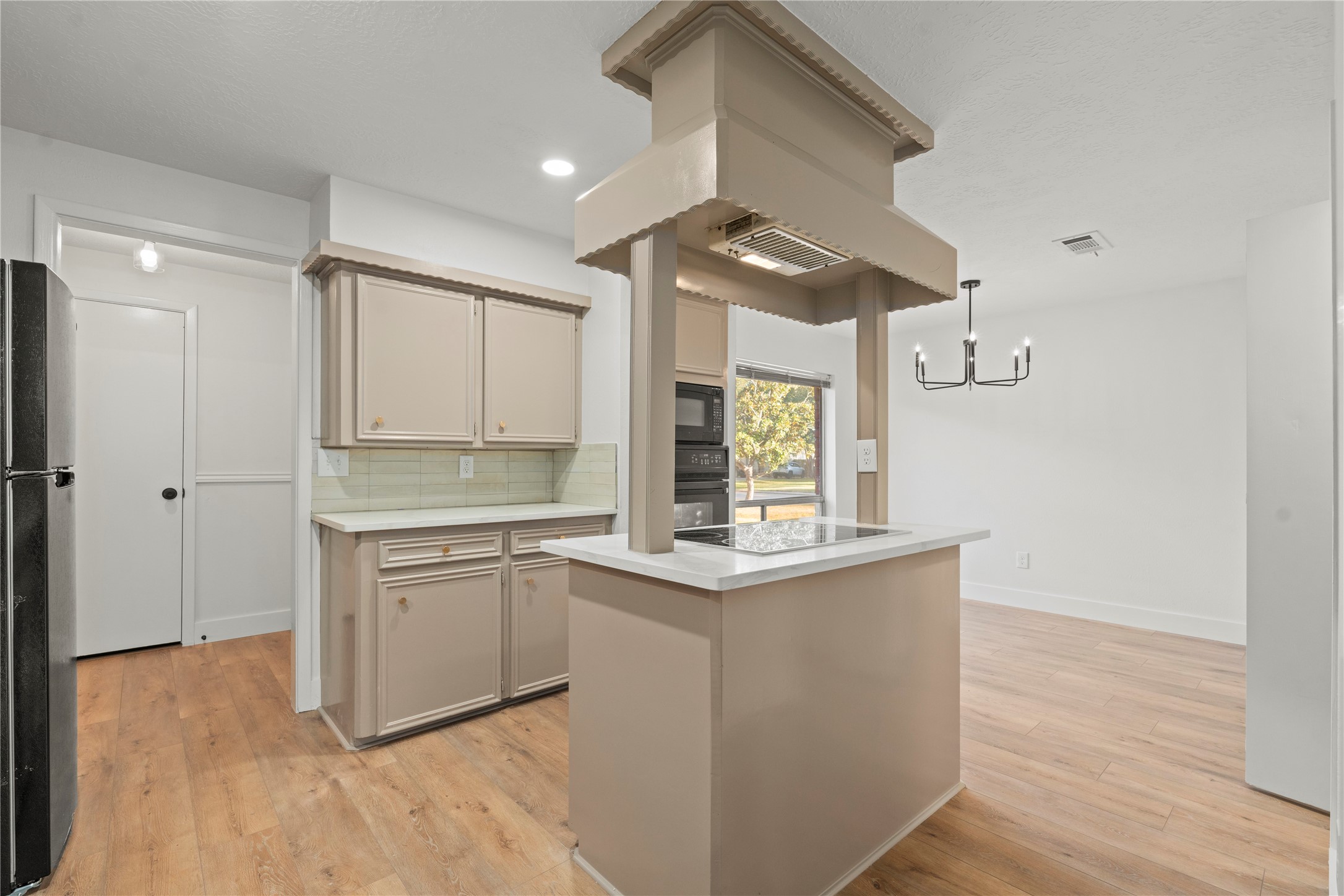 19415 Enchanted Oaks Drive Spring, TX 77388 - Photo 7 of 48 a kitchen with white cabinets and window