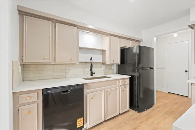 a kitchen with a sink a refrigerator a washer and dryer