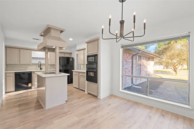 a view of a kitchen with refrigerator and wooden floor