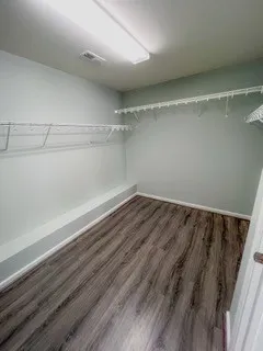 a view of a room with wooden floor