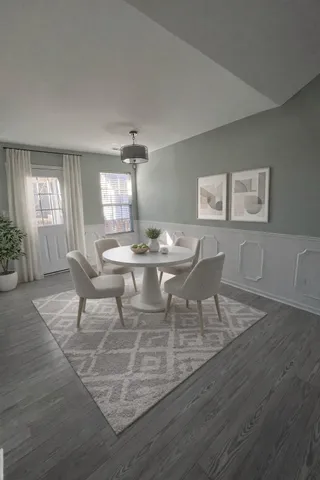 a dining room with furniture and wooden floor