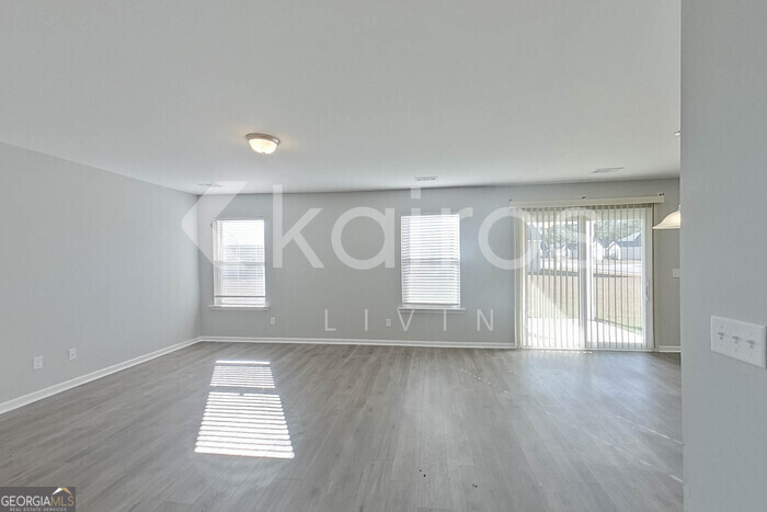 101 St Matthew Way Springfield, GA 31329 - Photo 4 of 30 an empty room with wooden floor and windows