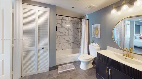 a bathroom with a double vanity sink toilet and shower