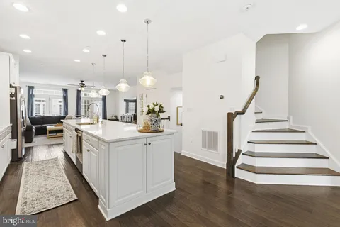 a view of a kitchen with cabinets and wooden floor