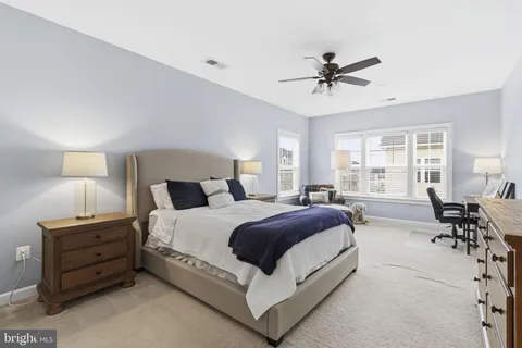 a spacious bedroom with a bed and window