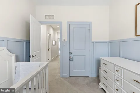 a view of a hallway to a livingroom with furniture