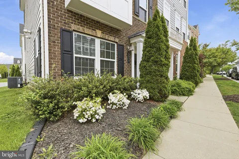 front view of a brick house with a yard