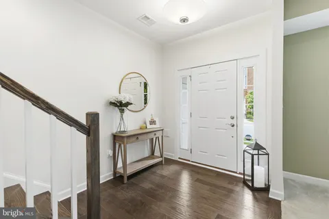 a view of a livingroom with wooden floor and staircase