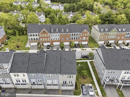 an aerial view of residential houses with outdoor space