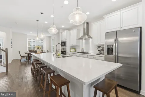 a large kitchen with a table and chairs