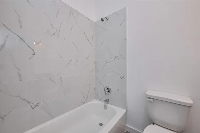 a bathroom with a bathtub and toilet
