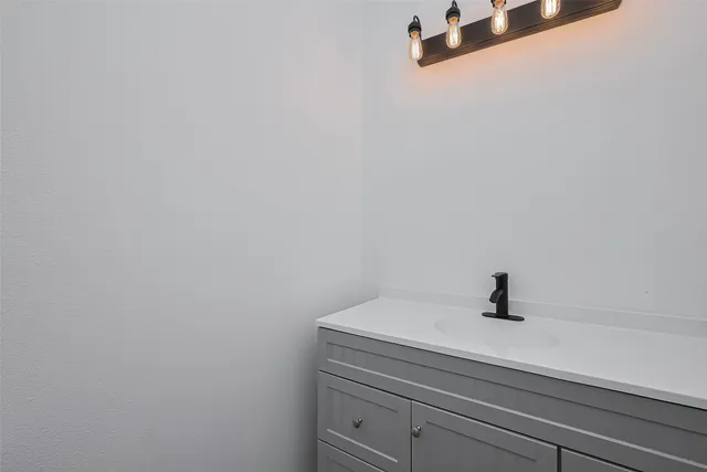 a bathroom with a sink and vanity