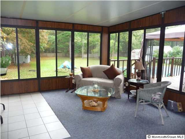 708 Cassville Road Jackson, NJ 08527 - Photo 2 of 3 a living room with furniture and a floor to ceiling window