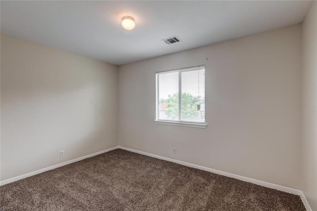 16712 Hamilton Point Circle Manor, TX 78653 - Photo 19 of 38 Plush carpeting anchors this versatile room under a smooth ceiling with central lighting.